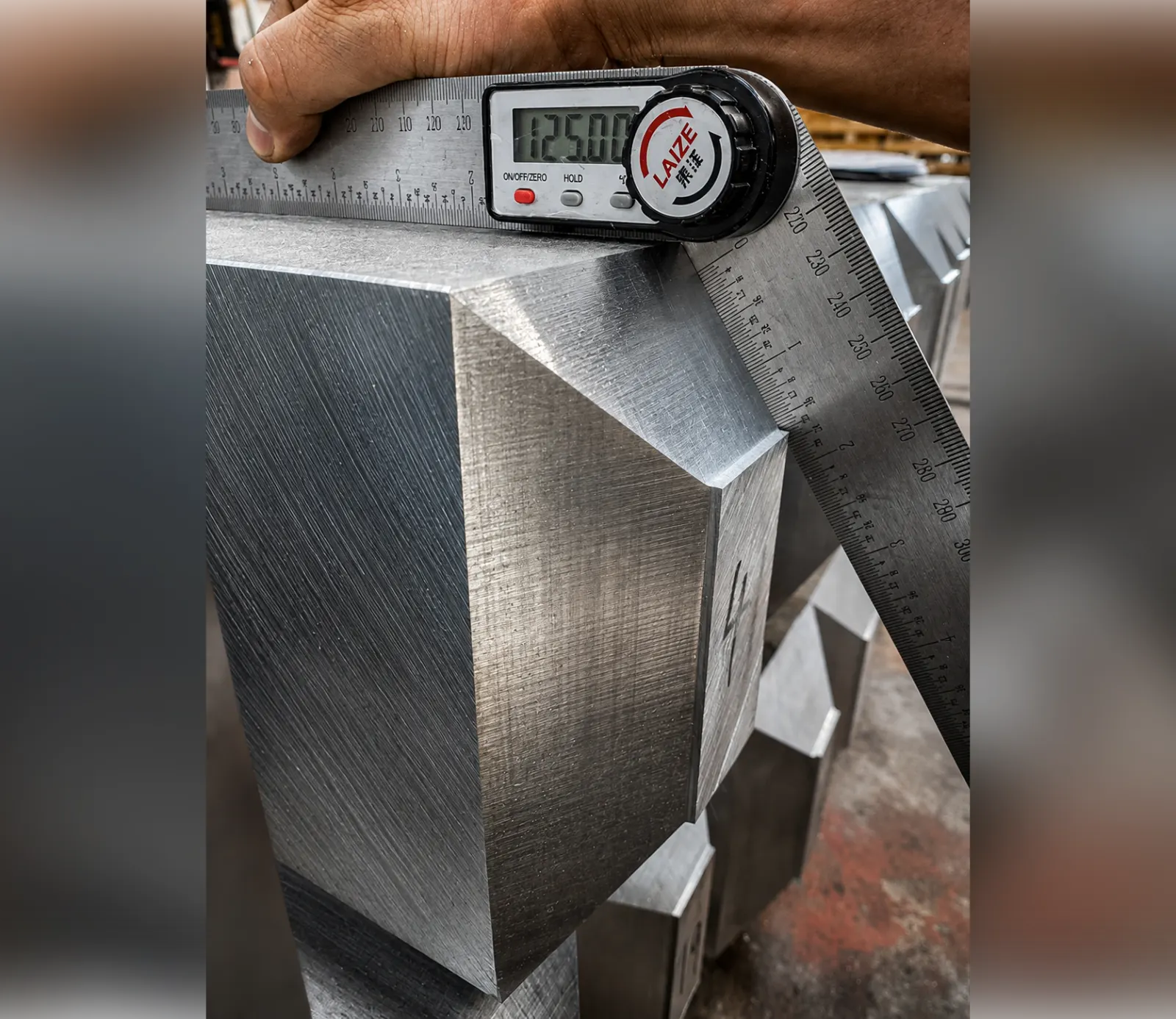 Machined aluminium component checked with a digital angle gauge