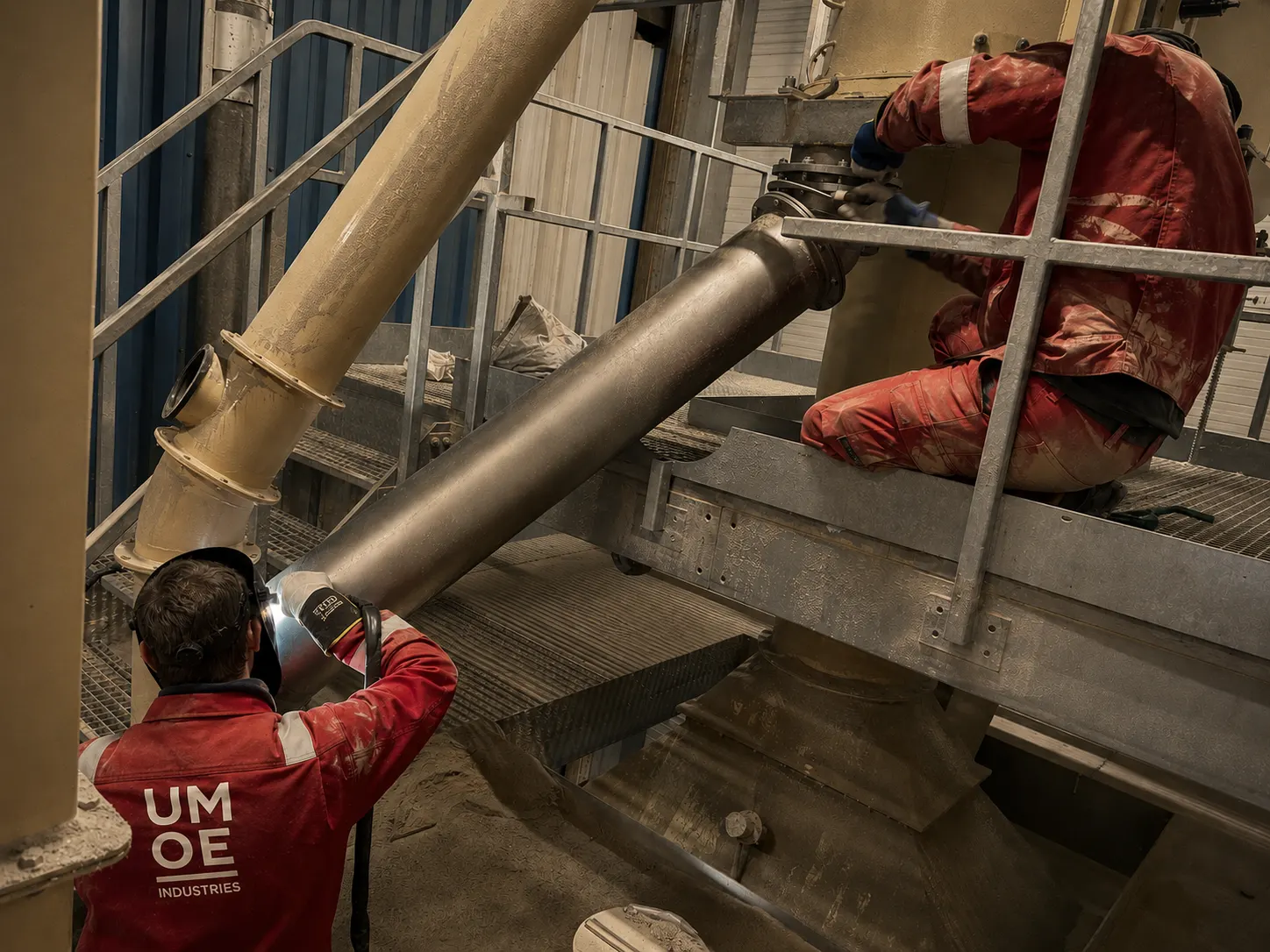 Umoe Industries welders fitting pipework and plate sections inside a plant